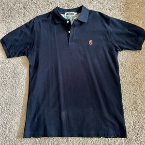Bape- A Bathing Ape short sleeve polo. Black front with custom ‘camo print’ back